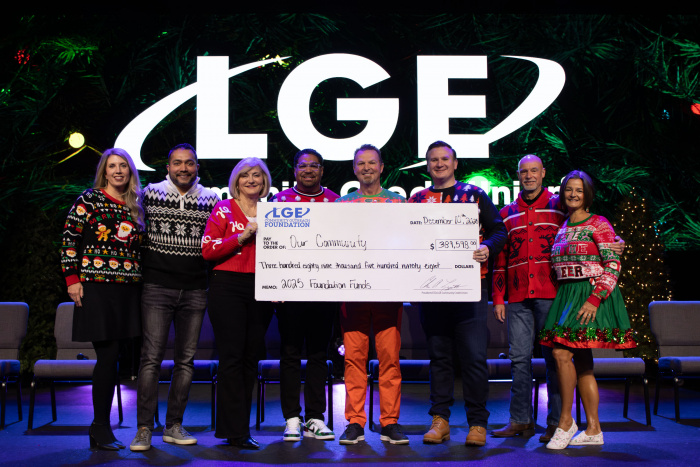 Members of the LGE Community Credit Union Leadership Team hold a check to our community for 39,598 dollars at the annual celebration breakfast