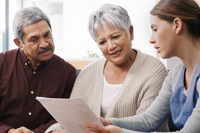 Elderly couple looking over paperwork with planner