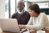 husband and wife looking at computer together