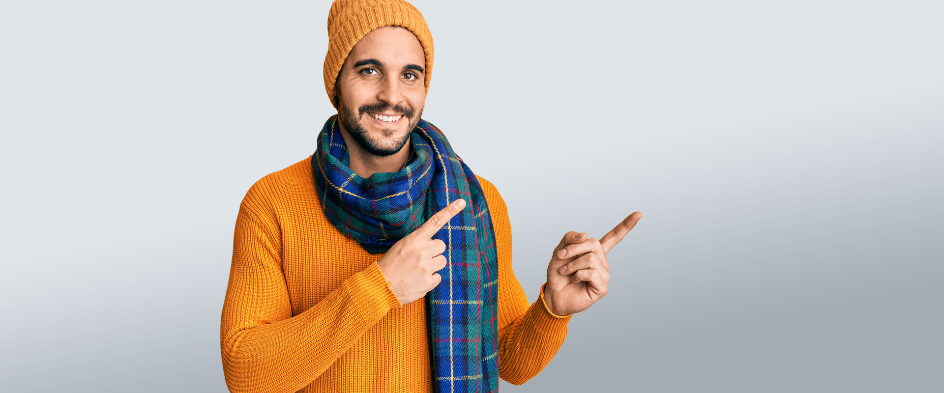 Man with Scarf and Sweater pointing
