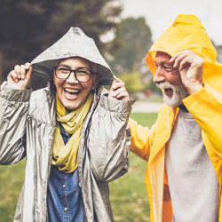 A woman and man outside in rain jackets